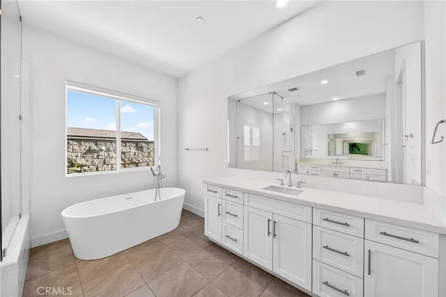 a bathroom with a granite countertop sink mirror bathtub and shower