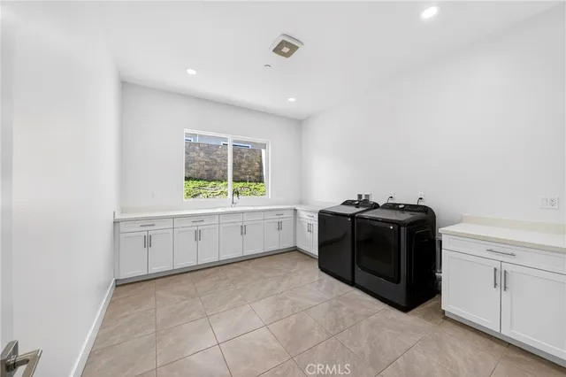 a spacious bathroom with a double vanity sink a mirror and a bathtub