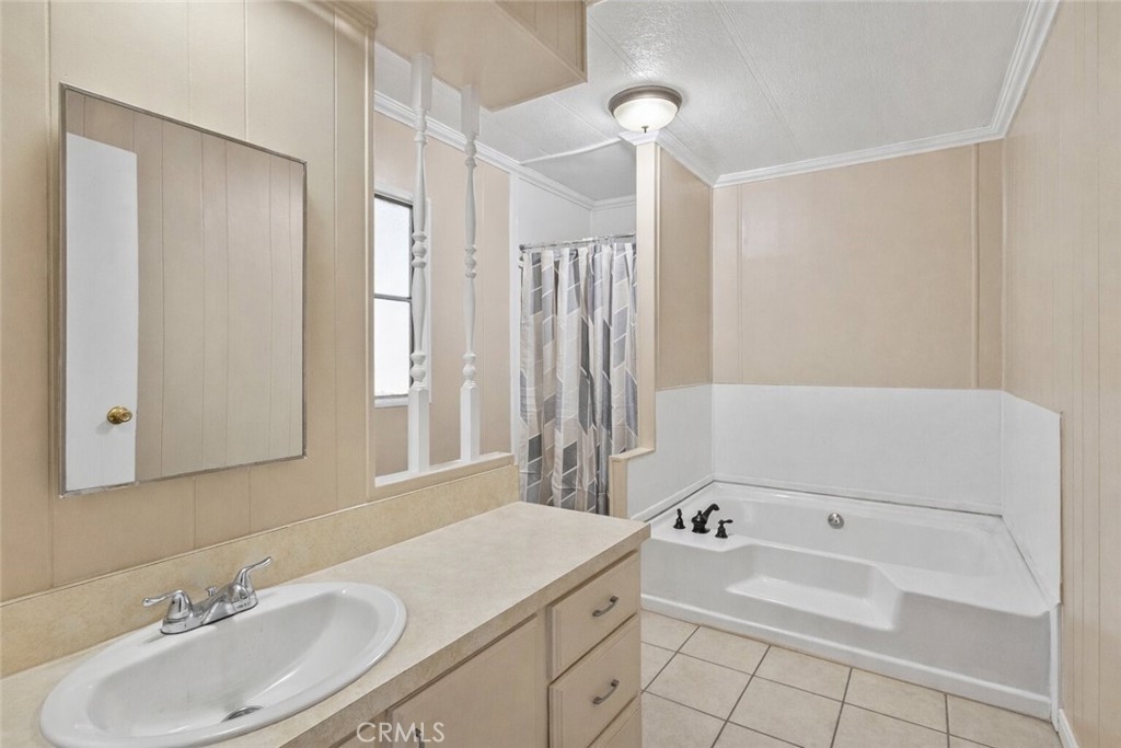 22838 Bear Valley Road, Unit 64 Apple Valley, CA 92308 - Photo 14 of 22 a bathroom with a tub sink and mirror