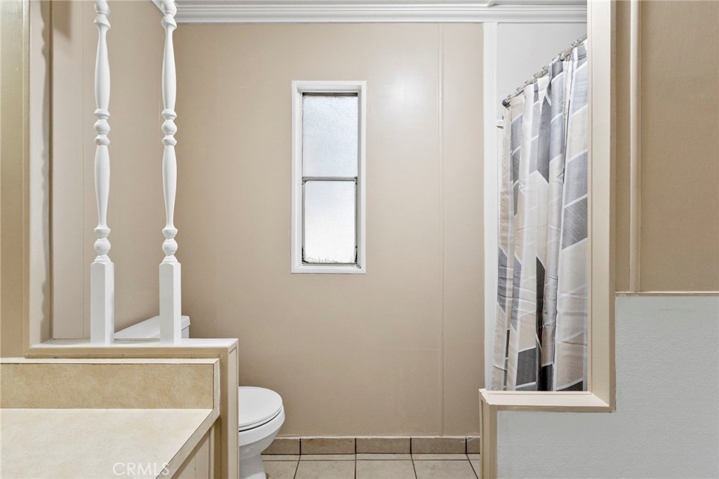 22838 Bear Valley Road, Unit 64 Apple Valley, CA 92308 - Photo 15 of 22 a bathroom with a toilet and a mirror