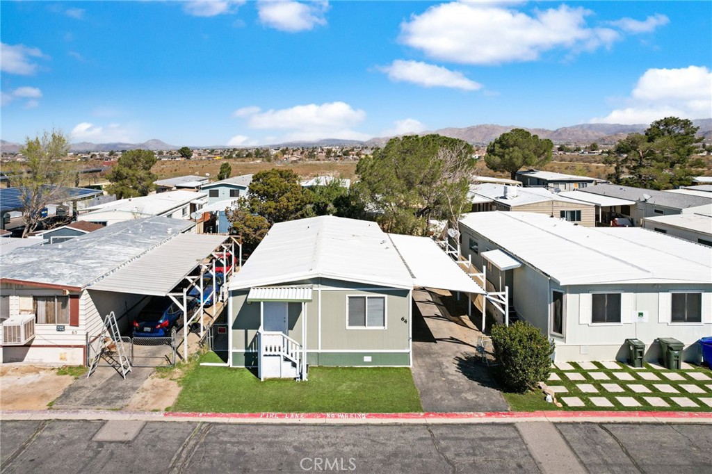 22838 Bear Valley Road, Unit 64 Apple Valley, CA 92308 - Photo 18 of 22 a aerial view of a house next to a yard