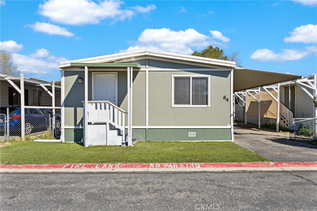 22838 Bear Valley Road, Unit 64 Apple Valley, CA 92308 - Photo 2 of 22 a view of a house with a yard