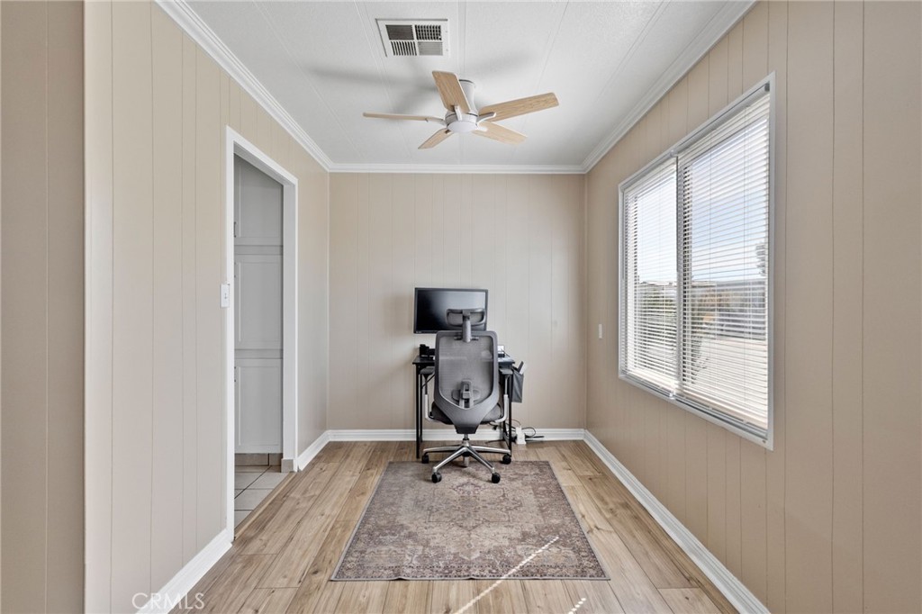 22838 Bear Valley Road, Unit 64 Apple Valley, CA 92308 - Photo 5 of 22 a view of a workspace with furniture and a window