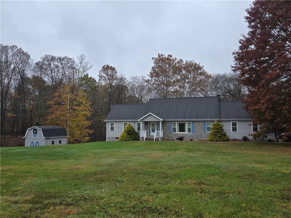 205 Hamburg Road Greenville, PA 16125 - Photo 1 of 39 a house that is sitting in the grass with large trees and plants