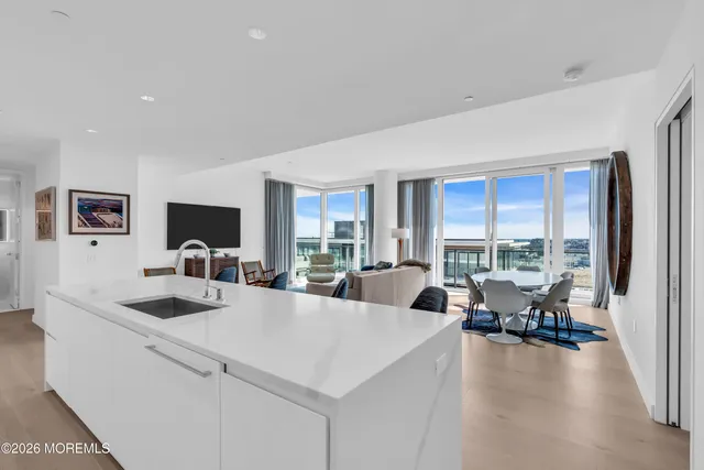 a living room with furniture a mirror and a flat screen tv