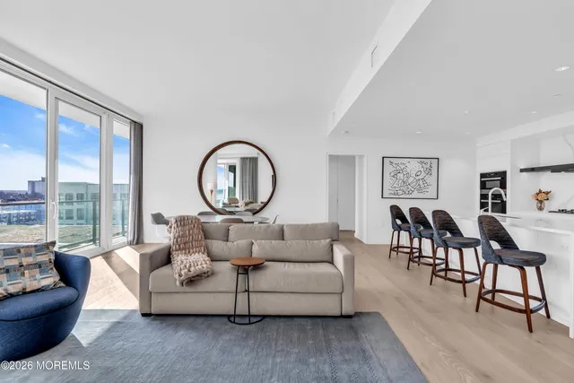 a living room with furniture a mirror and a table