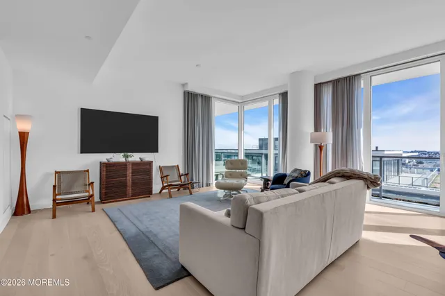 a bedroom with a large bed and a flat screen tv