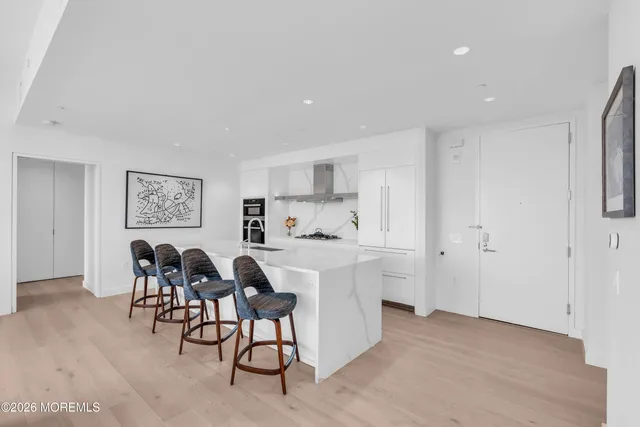 a bedroom with a bed a mirror and a window