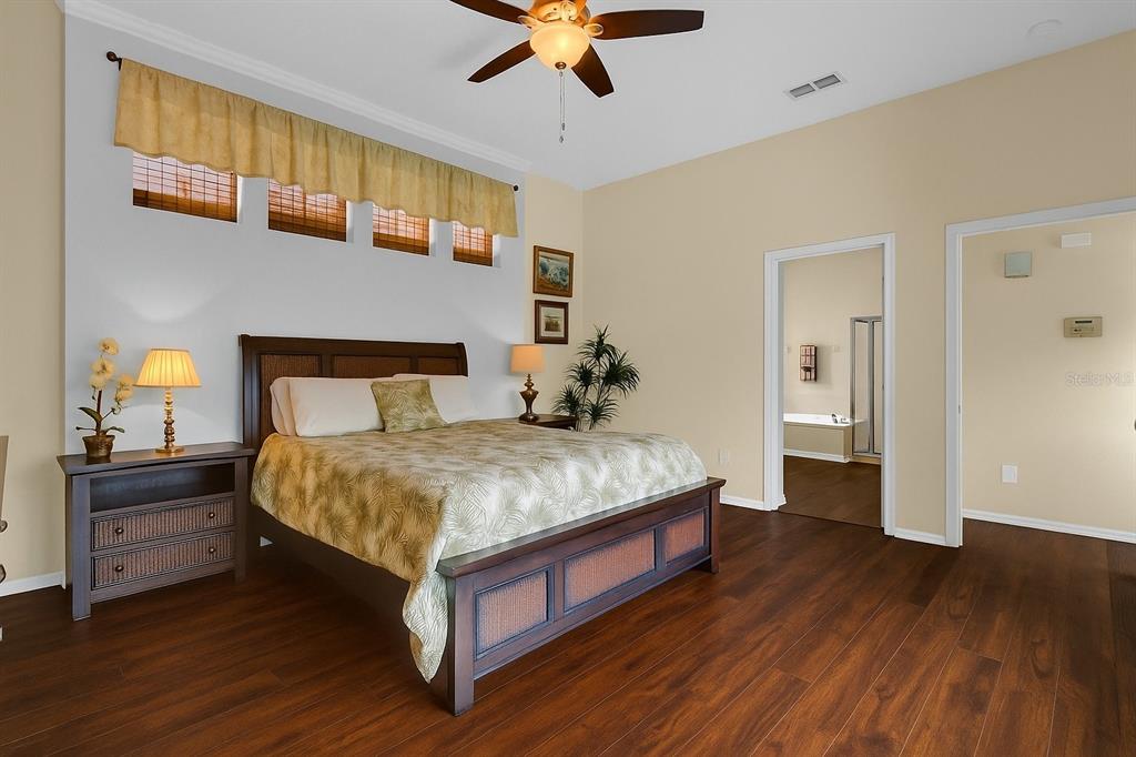 604 Nadina Place Celebration, FL 34747 - Photo 13 of 32 a bedroom with a bed and wooden floor