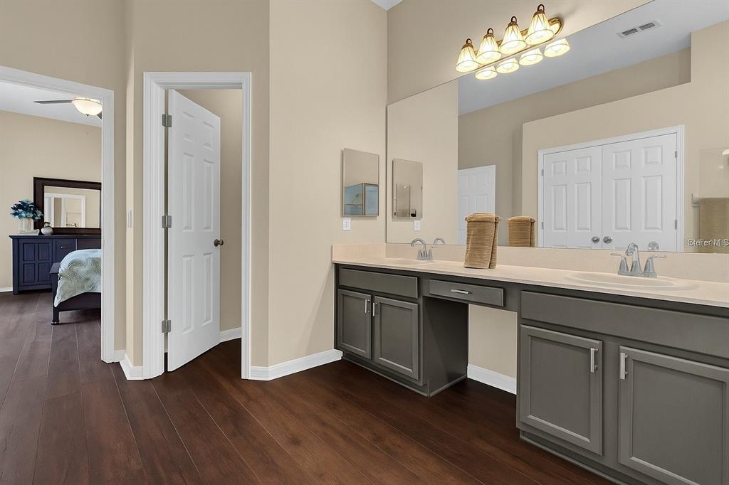 604 Nadina Place Celebration, FL 34747 - Photo 16 of 32 a en suite bathroom with a double vanity sink and a mirror