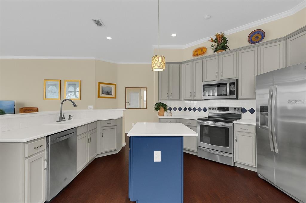 604 Nadina Place Celebration, FL 34747 - Photo 8 of 32 a kitchen with stainless steel appliances white cabinets and sink