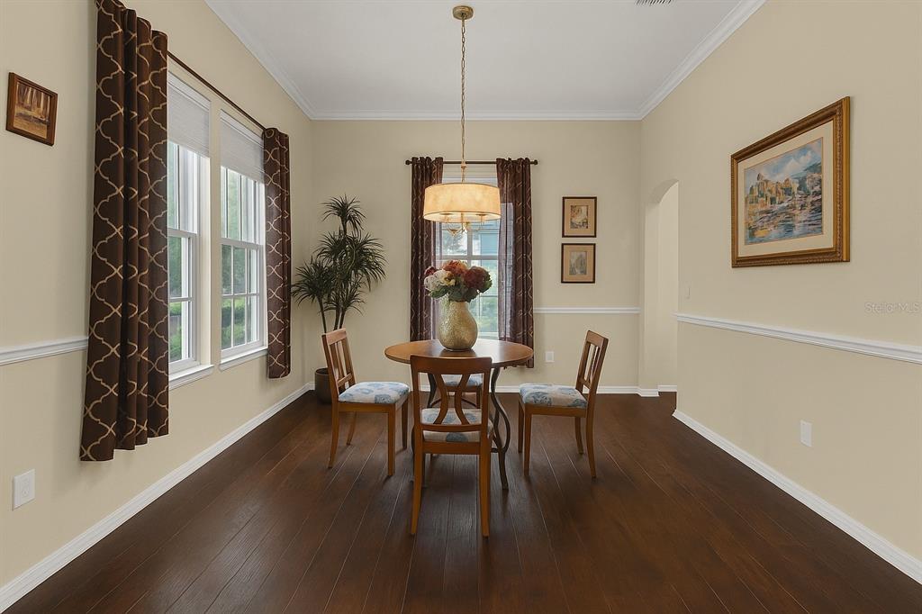604 Nadina Place Celebration, FL 34747 - Photo 9 of 32 a dining room with furniture wooden floor a chandelier