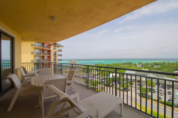 a view of a balcony with chair and table
