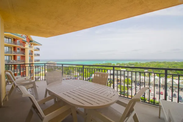 a view of a balcony with wooden floor and outdoor space