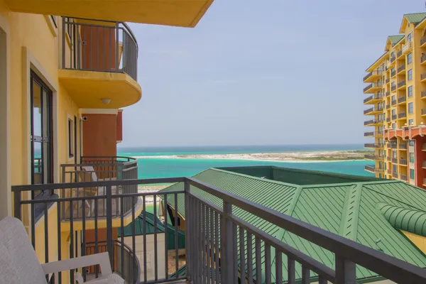 a view of a balcony with two chairs