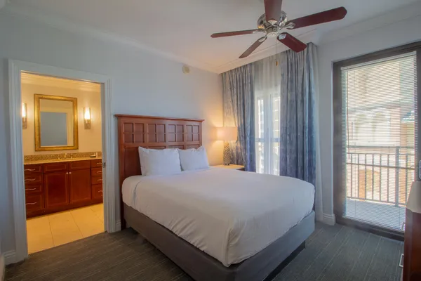 a bedroom with a large bed and a window