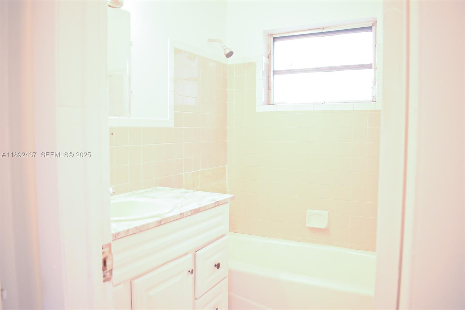 2265 Northwest 98th Street, Unit 2265 Miami, FL 33147 - Photo 15 of 15 a bathroom with a bathtub and a shower