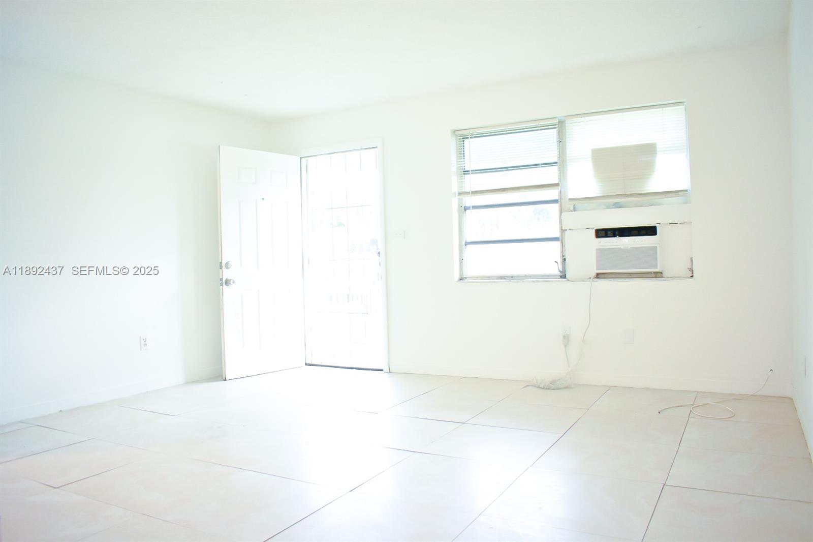 2265 Northwest 98th Street, Unit 2265 Miami, FL 33147 - Photo 2 of 15 a view of a room that has a window in it