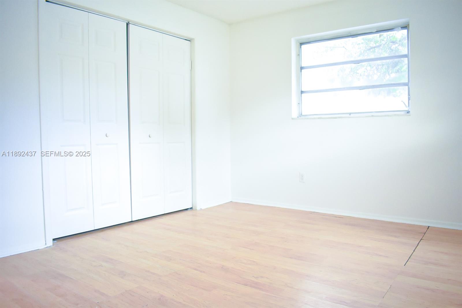 2265 Northwest 98th Street, Unit 2265 Miami, FL 33147 - Photo 8 of 15 an empty room with a window