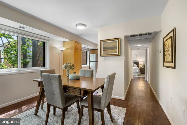 a view of a dining room with furniture and wooden floor