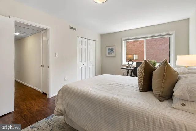 a bedroom with a bed and a window