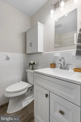 a bathroom with a sink a toilet and mirror