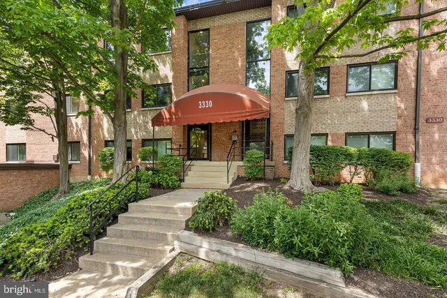 a front view of a house with yard and green space
