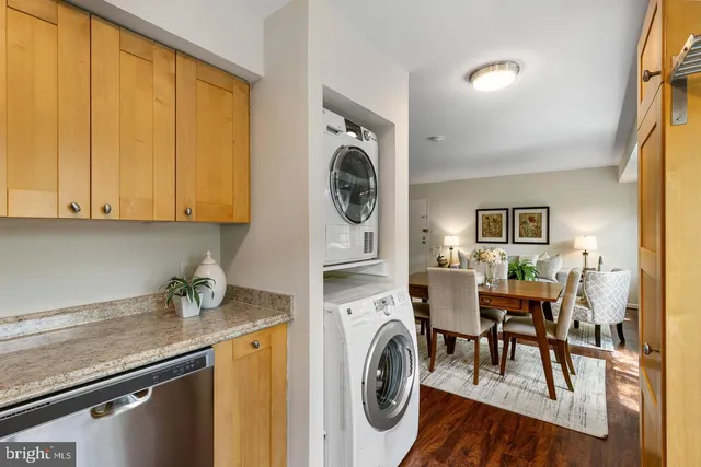 a view of a kitchen filled with furniture and wooden floor