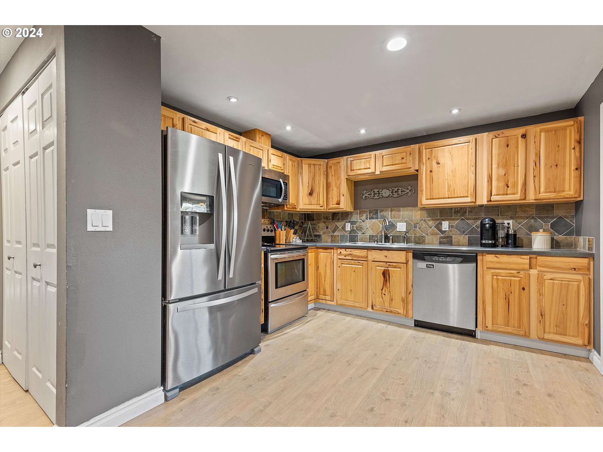 3825 Southeast 6th Street Gresham, OR 97080 - Photo 19 of 37 a kitchen with granite countertop stainless steel appliances a refrigerator sink and microwave