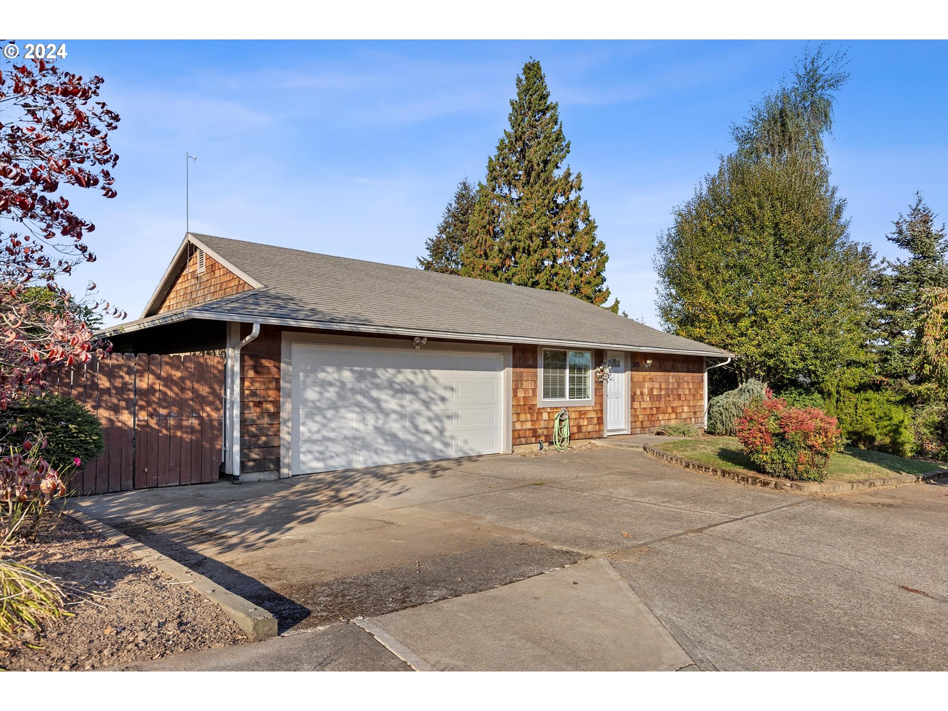 3825 Southeast 6th Street Gresham, OR 97080 - Photo 2 of 37 a view of a house with a yard and garage