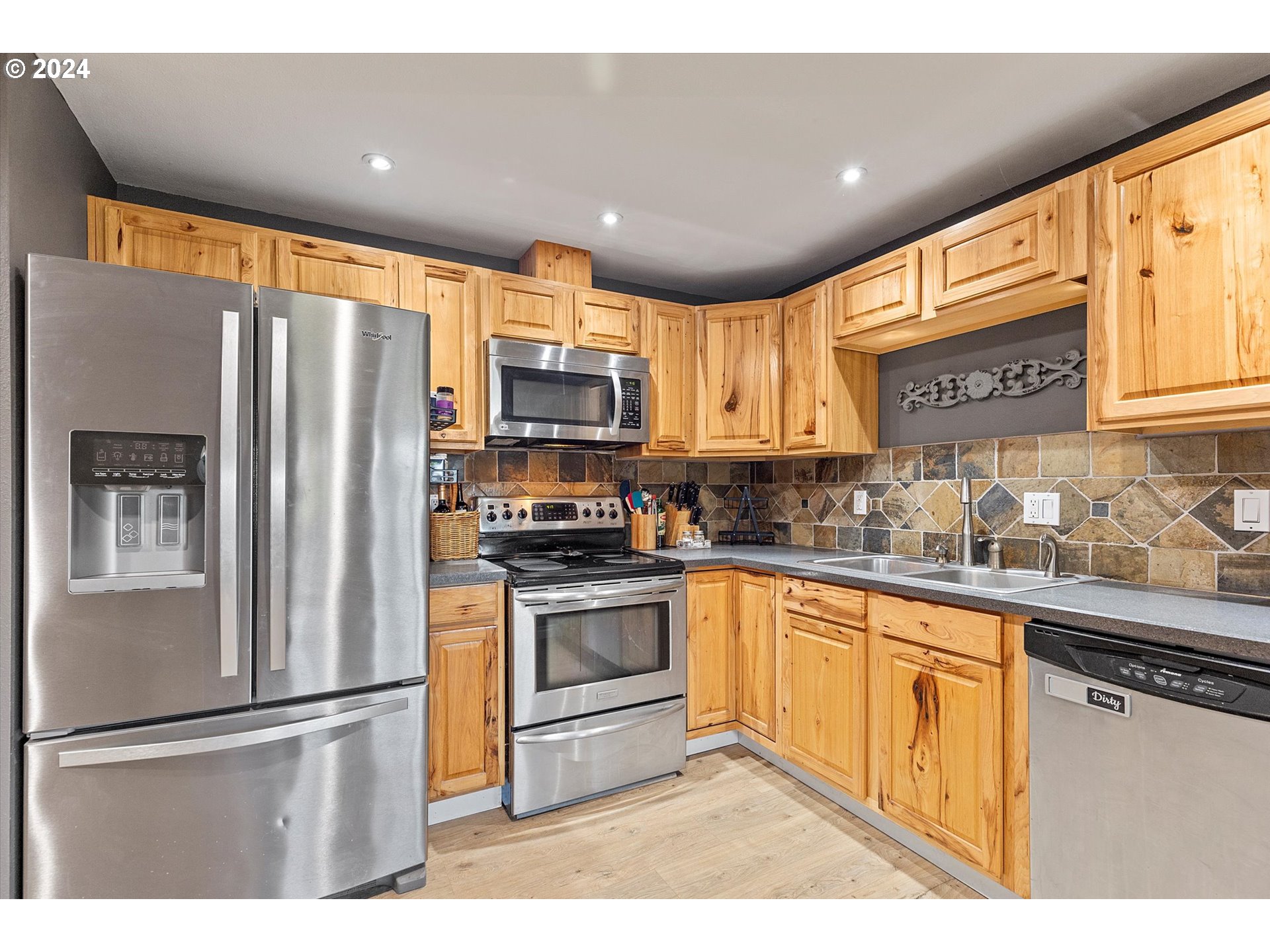 3825 Southeast 6th Street Gresham, OR 97080 - Photo 21 of 37 a kitchen with stainless steel appliances granite countertop a refrigerator sink and cabinets