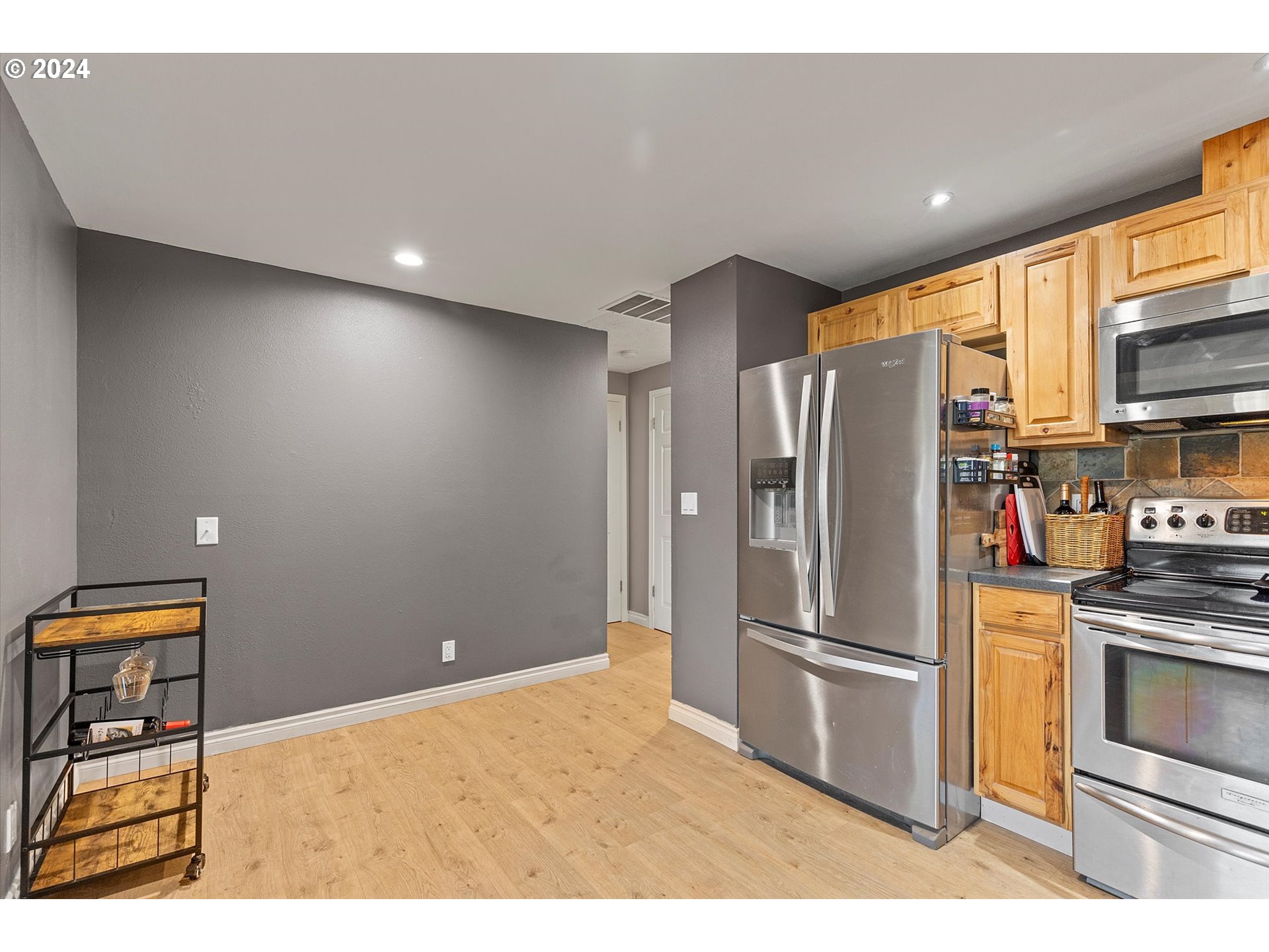 3825 Southeast 6th Street Gresham, OR 97080 - Photo 22 of 37 a kitchen with stainless steel appliances a refrigerator and a stove top oven