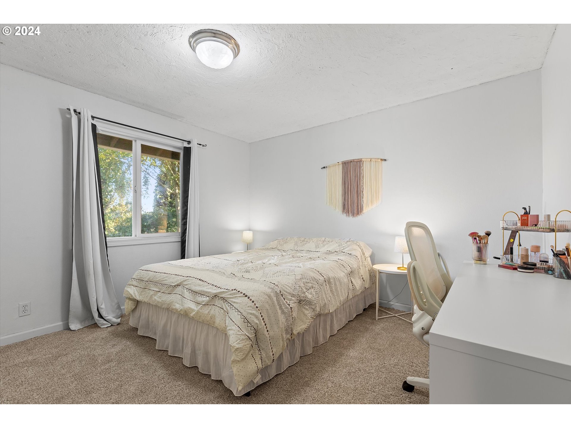 3825 Southeast 6th Street Gresham, OR 97080 - Photo 6 of 37 a bedroom with a bed a chair and potted plant next to a window