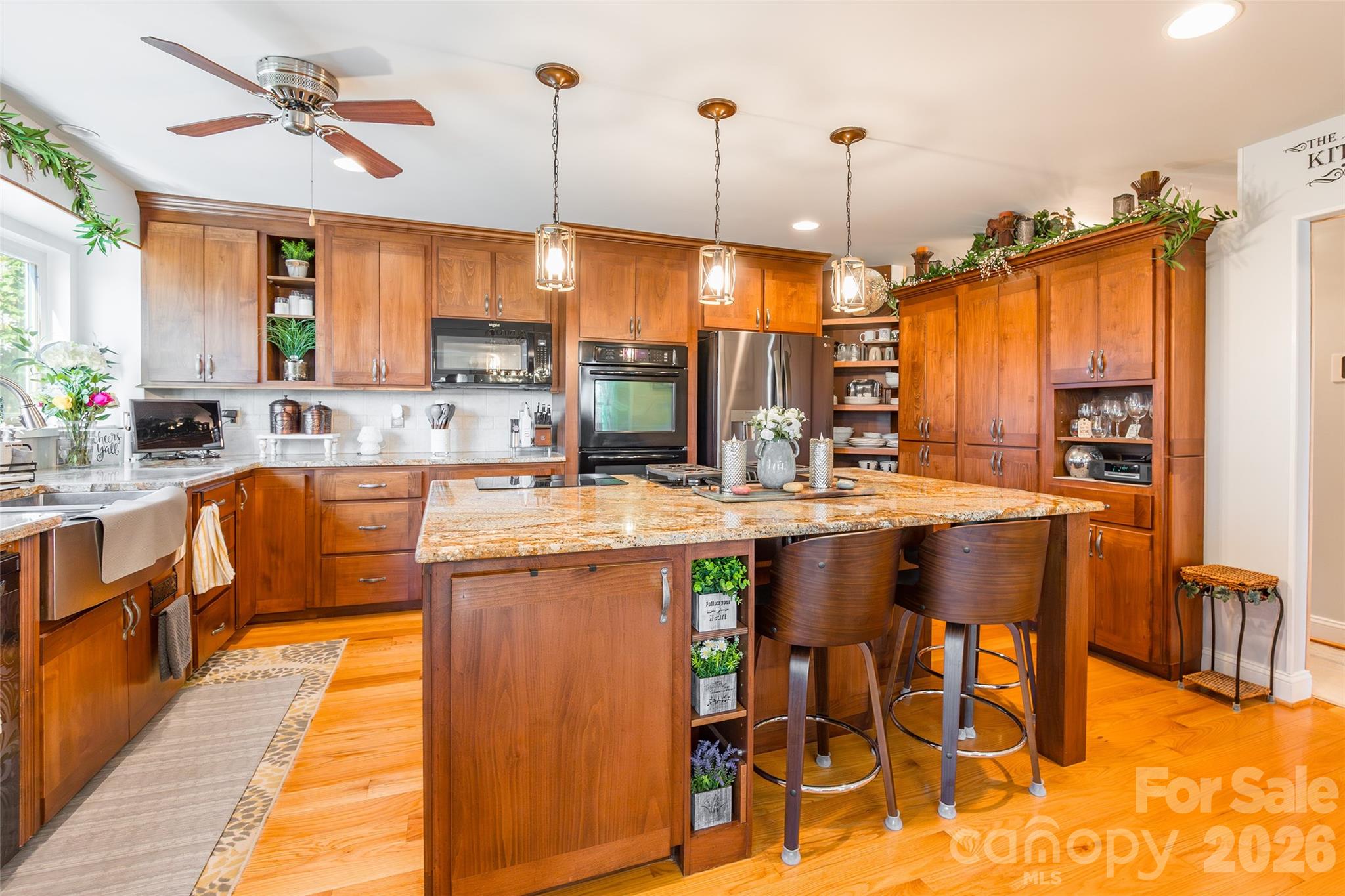 4205 Lake Shore Road South Denver, NC 28037 - Photo 12 of 46 a kitchen with stainless steel appliances granite countertop a stove top oven a sink and a dining table