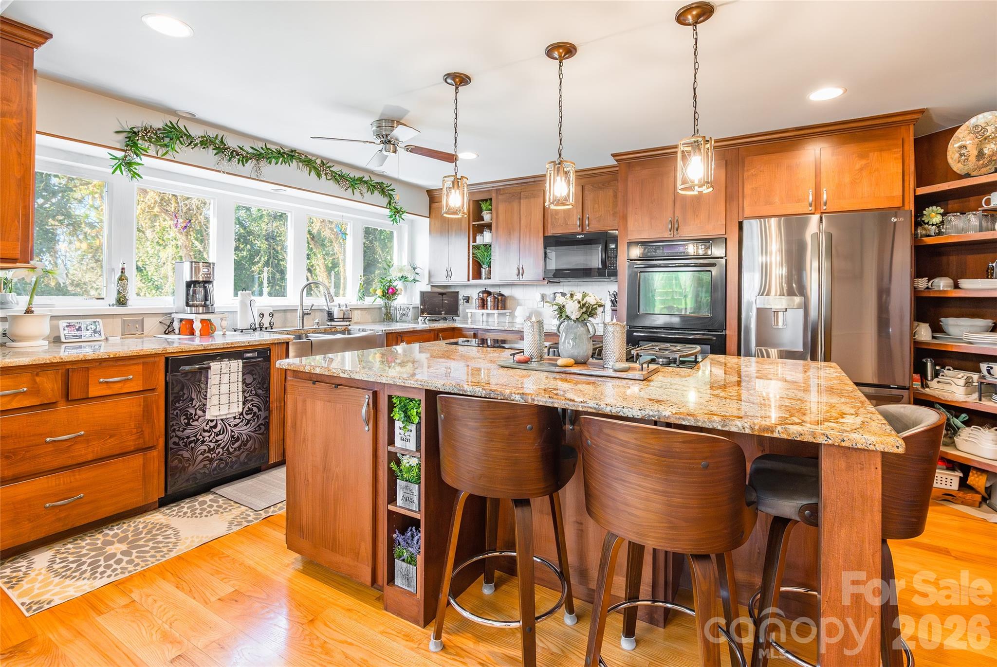 4205 Lake Shore Road South Denver, NC 28037 - Photo 13 of 46 a kitchen with stainless steel appliances granite countertop a stove a sink dishwasher and cabinets with wooden floor