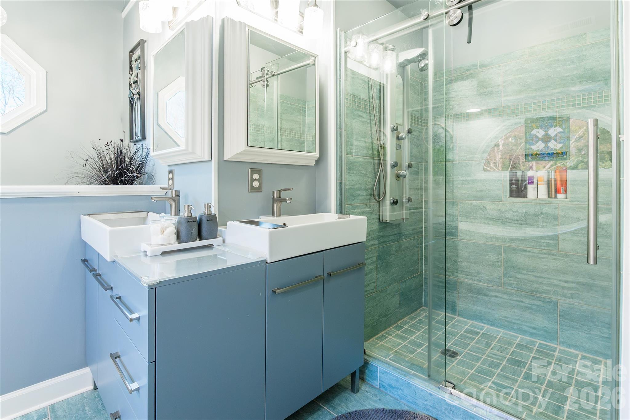 4205 Lake Shore Road South Denver, NC 28037 - Photo 25 of 46 a bathroom with a shower sink and mirror