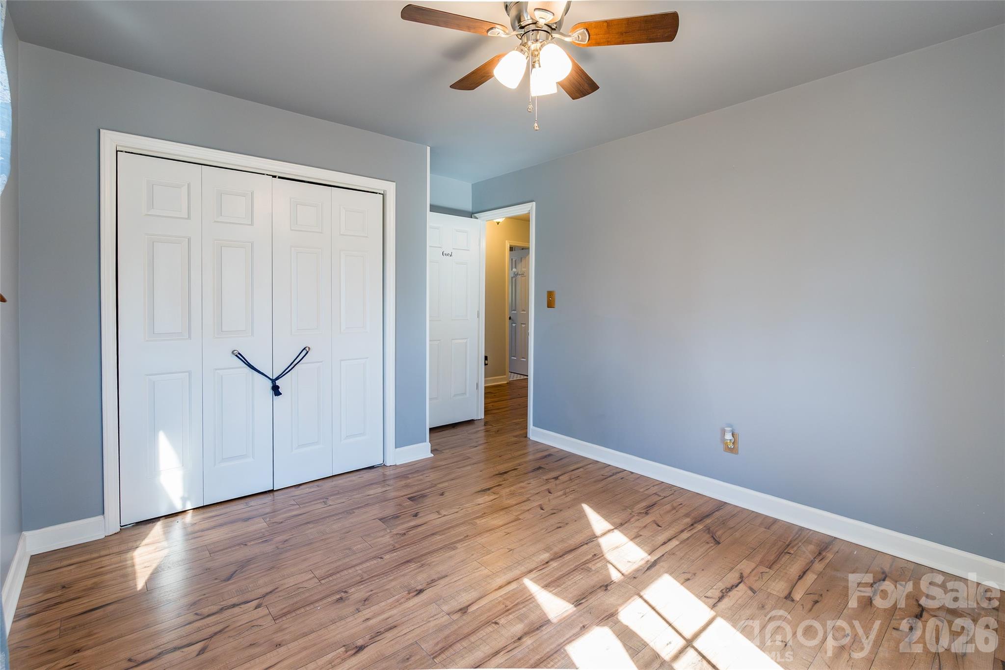 4205 Lake Shore Road South Denver, NC 28037 - Photo 31 of 46 an empty room with wooden floor closet and windows