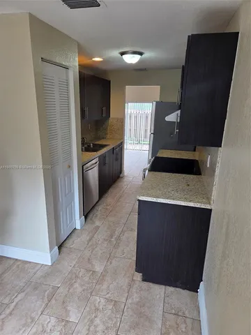 a kitchen with a sink and a stove top oven