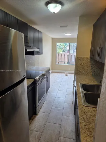 a kitchen with a sink stainless steel appliances and cabinets