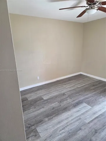 a view of a room with wooden floor