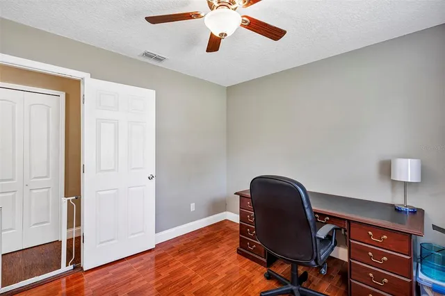 a view of a workspace with furniture and wooden floor