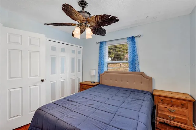 a bedroom with a bed and a window