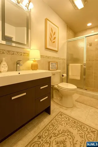 a kitchen with a sink stove and wooden floor