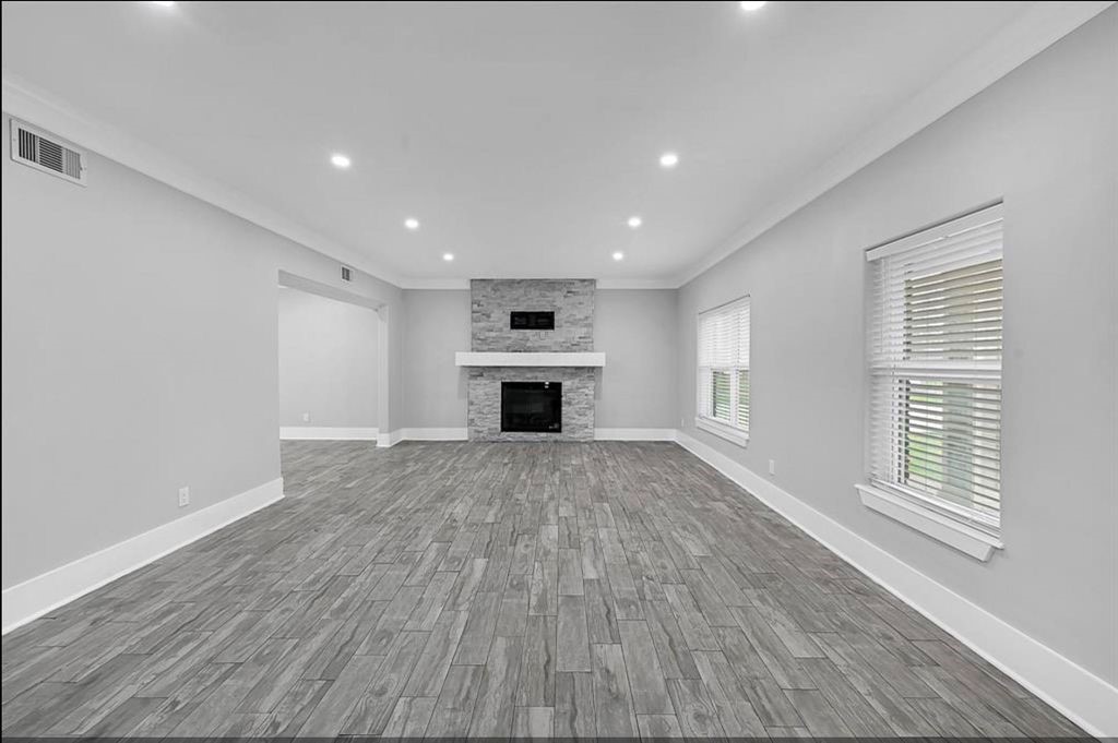 12430 Pecan Court Houston, TX 77013 - Photo 3 of 10 a view of empty room with a fireplace and wooden floor