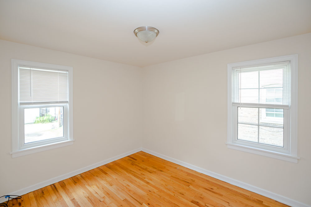 4245 West Nelson Street, Unit 1 Chicago, IL 60641 - Photo 8 of 8 a view of an empty room with wooden floor and a window