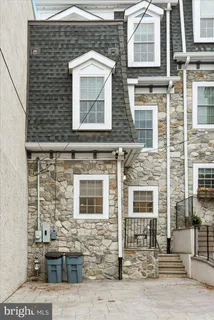 a front view of a brick house with many windows