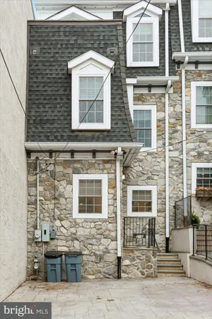 a front view of a brick house with many windows