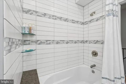 a bathroom with a bathtub and shower