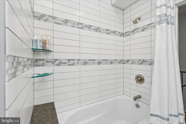 a bathroom with a bathtub and shower