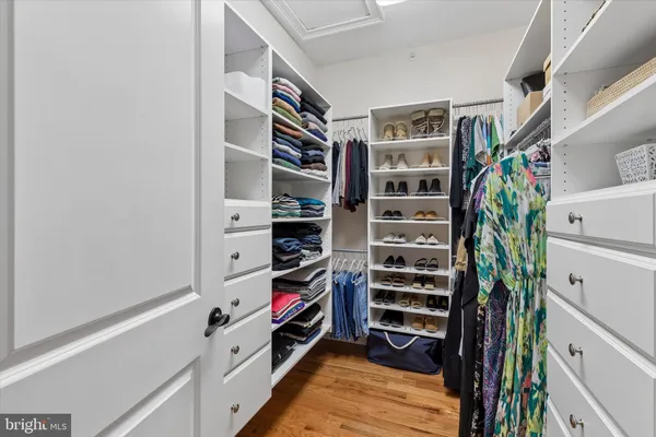 a view of walk in closet with empty racks